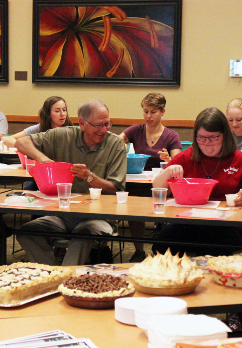 Adults participating in a cooking event at